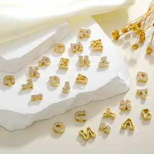 Macro shot of 26 gold copper alphabet pendants with micro-paved cubic zirconia