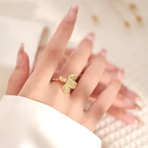 Macro detail of 18K gold plated geometric ring with sparkling butterfly zircon settings