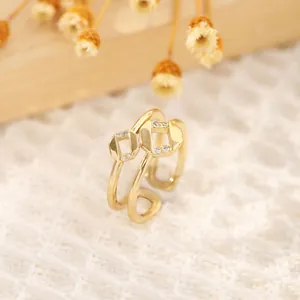 Close-up of 18K gold plated octagonal geometric ring with white zircon stones on lace