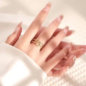 Detail of 18K gold plated geometric ring stack with zircon stones on model finger