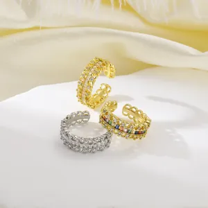 Detail of vintage gold-plated open rings with colorful zircon and lace hollow patterns