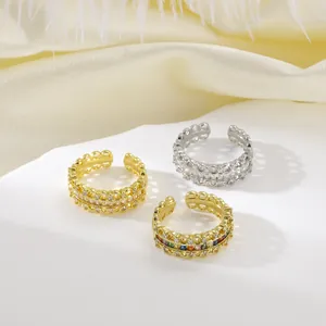 Detailed macro of gold and silver plated adjustable rings with colorful zircon inlay