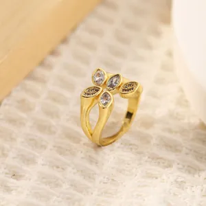 Macro detail of 18K gold-plated flower ring with marquise zircon and black accents