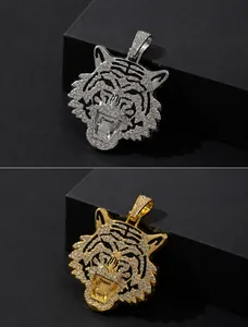 Detailed view of hip-hop tiger head pendants in gold and silver with full diamond inlay