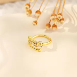 Close-up of a vintage 18K gold plated copper ring with zircon stones and golden beads