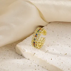 Detailed macro view of gold plated vintage ring with colorful zircon stones and hollow pattern