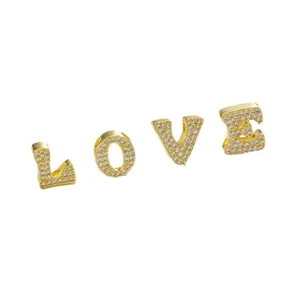Golden alphabet pendants with micro-paved zircons forming LOVE for DIY jewelry