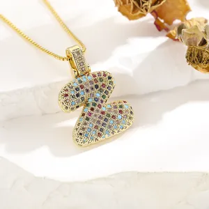Macro view of gold letter Z pendant necklace with colorful cubic zirconia inlay
