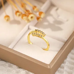 Close-up of geometric 18K gold plated ring with double-row zircon in a beige jewelry box