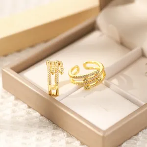 Detailed close-up of two 18K gold plated copper rings with micro-set zircon stones