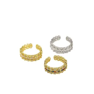 Three vintage adjustable rings with woven design and colorful zircons in gold and silver