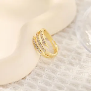 Close-up of triple-layered 18K gold-plated ring featuring zircon pavé and open design