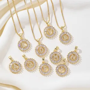 Gold plated initial letter pendant necklace with sparkling cubic zirconia sunburst design