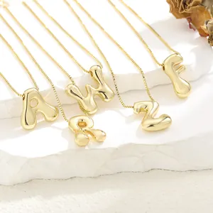 Detail of 3D gold-plated bubble letter pendants A W R Z F with polished finish on chain
