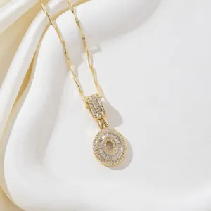 Détail du collier pendentif lettre O doré avec des zircons baguette et chaîne à vagues