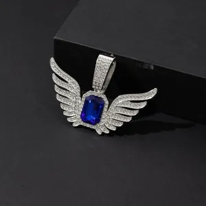 Detailed close-up of a silver angel wings pendant featuring a blue sapphire center stone