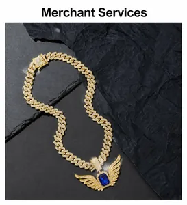 Macro detail of gold Cuban link chain with sapphire angel wing pendant and white crystals