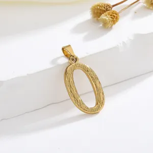 Macro-opname van gouden letter O-hanger met golvende textuur voor DIY sieraden