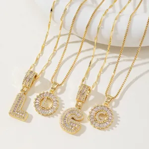 Golden alphabet pendant necklace set with sparkling zirconia crystals in various designs