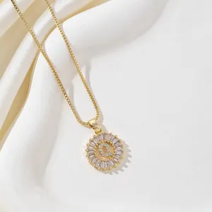 Golden round necklace with letter Q pendant and baguette zircon halo on box chain