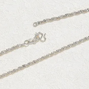 Macro shot of silver-plated melon seed chain with a secure M-clasp closure detail