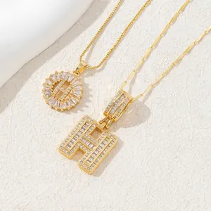 Golden letter H pendant necklace set with square and pavé-set sparkling zircons