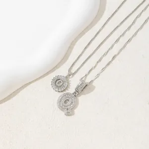 Detail of S925 silver letter Q pendant and sunburst necklace with cubic zirconia stones