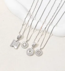 Detailed view of silver letter pendants with crystals on delicate chain necklaces
