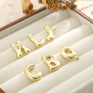Polished gold plated 3D bubble initial pendants displayed in a velvet jewelry box