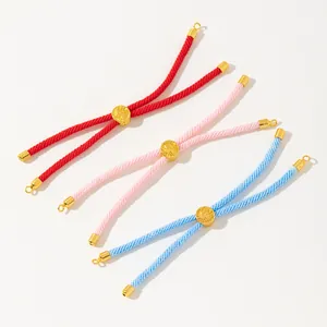 Three adjustable handmade woven bracelets in red pink and blue with golden tree of life charms