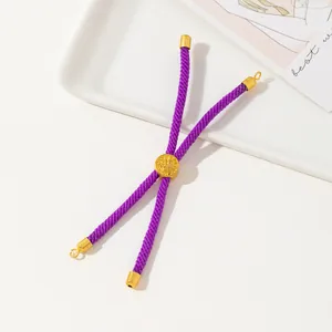 Detailed macro view of purple braided ropes with golden metal slide fastener and end caps