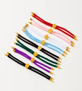 Macro shot of 8 colors braided cord bracelets with engraved golden charm beads