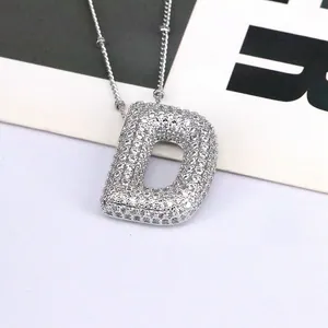 Silver tone crystal paved letter D pendant necklace with a 3D bubble design