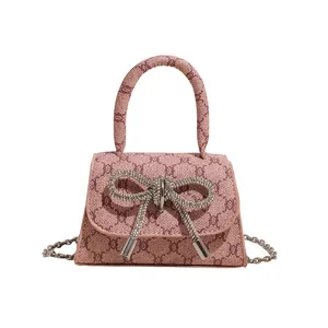 Mini bow handbag with vintage monogram fabric and silver rhinestone tassel charm