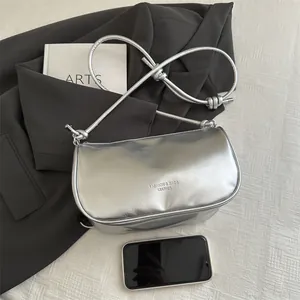 Silver metallic underarm pillow bag with knot strap and fashion lettering for women