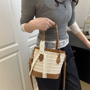Woven straw bucket bag with brown leather trim and lace ribbon for summer beach vacations
