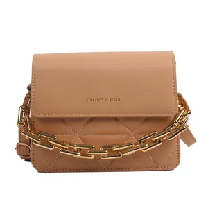 Brown quilted tote bag with golden chain strap and refined minimalist texture