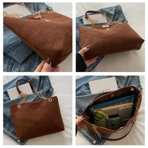Brown matte suede tote bag with gold deer pendant showing spacious interior capacity