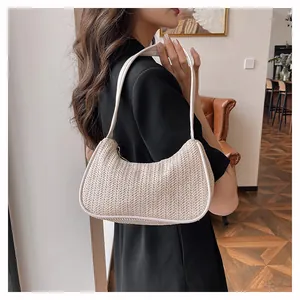 Detailed close-up showing woven texture and white leather trim of the chic summer underarm bag