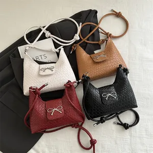 Chic woven tote bags with metal bows in white, tan, burgundy, and black finishes