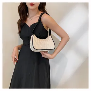 Fashion woven hobo bag with black contrast trim shown in a stylish lifestyle setting