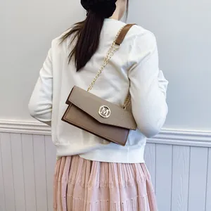 Women's chic bicolor crossbody square bag with gold M logo and chain strap
