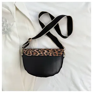 Detail view of a saddle bag with leopard print flap and stylish wide fabric strap
