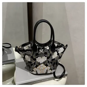 Exquisite floral embroidery on vintage black bucket bag with gold metal hardware