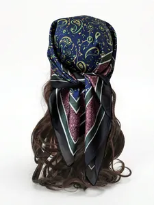 Detail of navy blue paisley silk scarf tied as a headband on a mannequin's hair