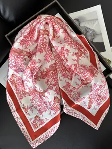 Detail of red floral silk scarf featuring elegant bird patterns and pomegranate branches