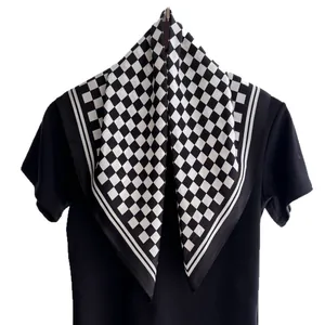 Classic black and white checkered silk square scarf with striped border on a display