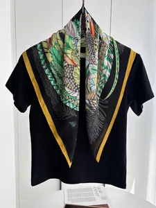Detailed view of vibrant tropical leaf print silk scarf with bright yellow edges