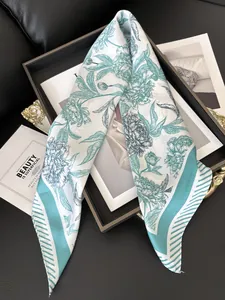 Macro view of floral silk scarf featuring peony print and stylish striped borders