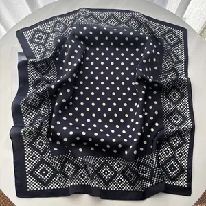 Detail of silk-like blue square scarf with white polka dots and geometric rhombus pattern